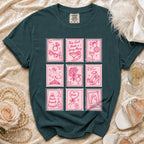 Teal t-shirt with pink stamp graphics of wedding symbols and text.