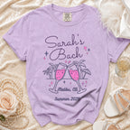 Purple t-shirt with "Sarah's Bach Malibu, Ca Summer 2026" text and toasting champagne glasses.
