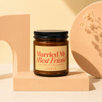 Amber glass candle with black lid and label reading "Married My Best Friend"