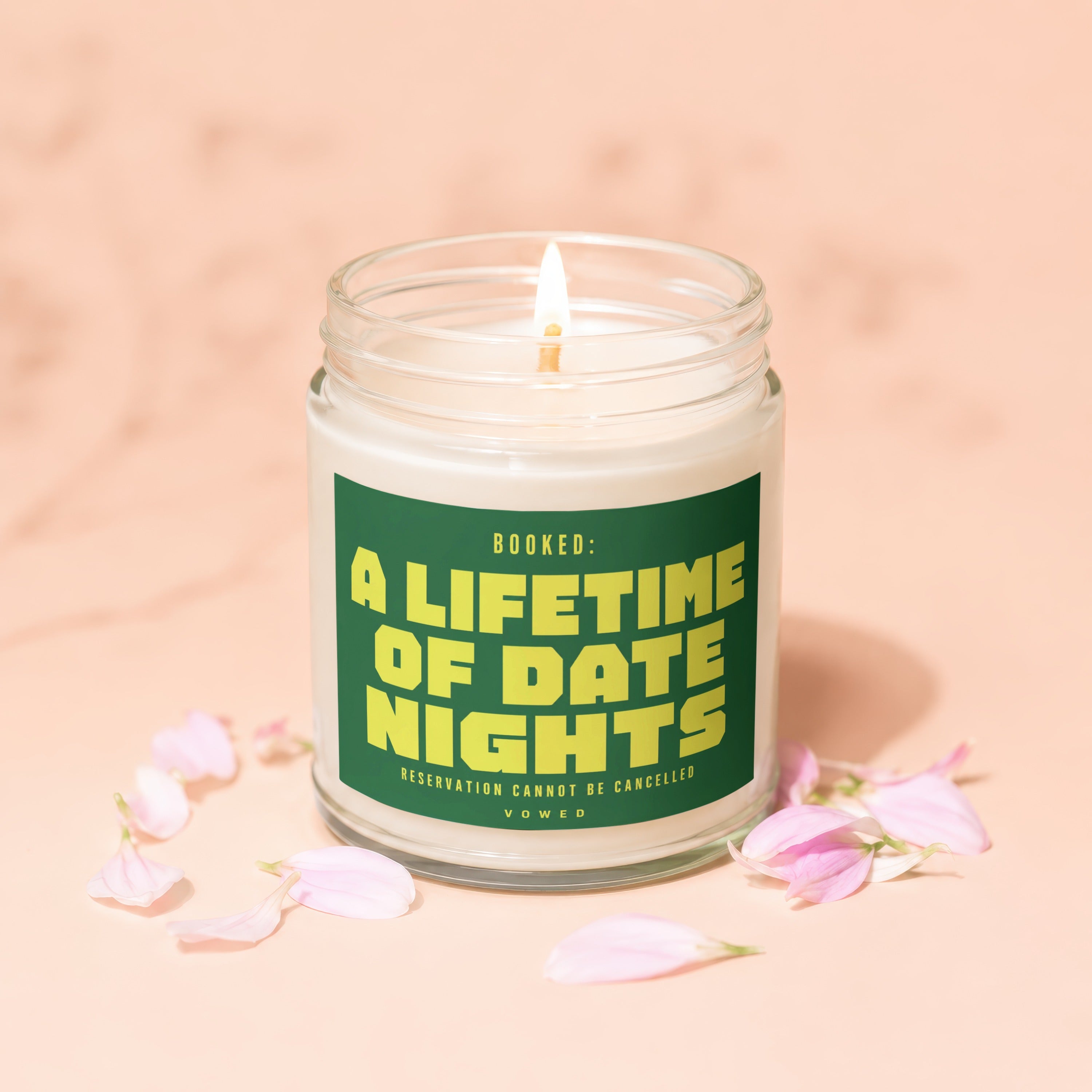 Jar candle with lit wick reading "Booked: A Lifetime Of Date Nights".