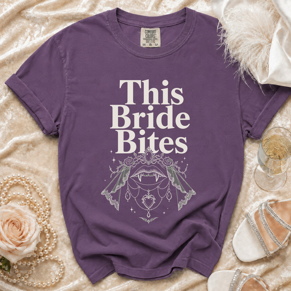 Purple t-shirt with "This Bride Bites" text and vampire-themed graphic.
