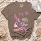 Brown t-shirt with "LUCKY" text, ghost, and romantic quote design.
