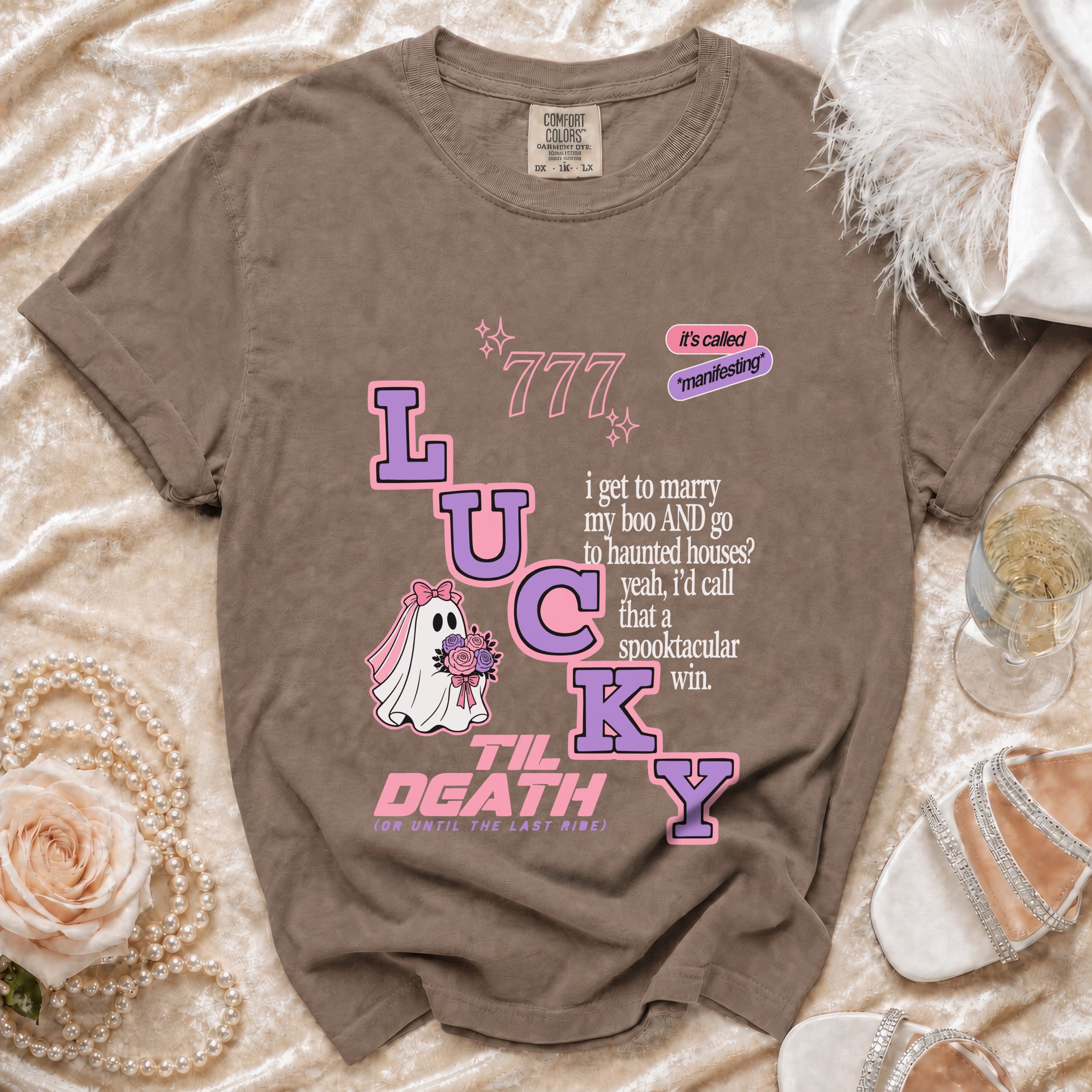 Brown t-shirt with "LUCKY" text, ghost, and romantic quote design.
