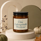 Amber candle with black lid, label reads "Smells Like One Unforgettable Weekend vowed".
