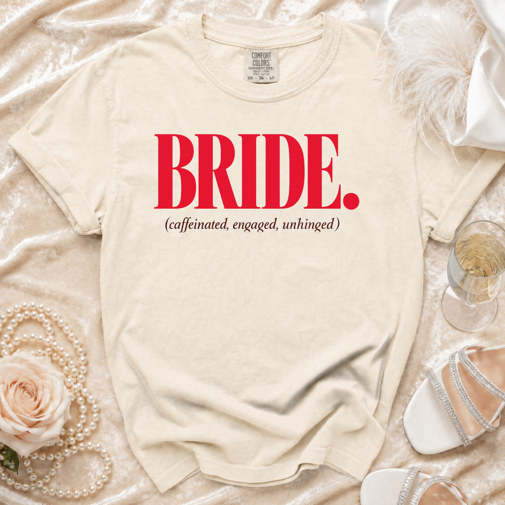 Cream t-shirt with "BRIDE. (caffeinated, engaged, unhinged)" in red and brown text.