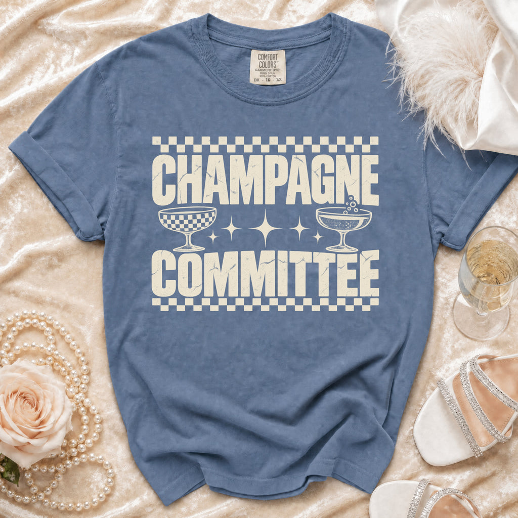 Blue t-shirt with cream text "CHAMPAGNE COMMITTEE" and champagne glasses.