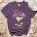 Purple t-shirt with margarita graphic and text: "This Girl Needs A Margarita. Bride Tribe Let's Celebrate."