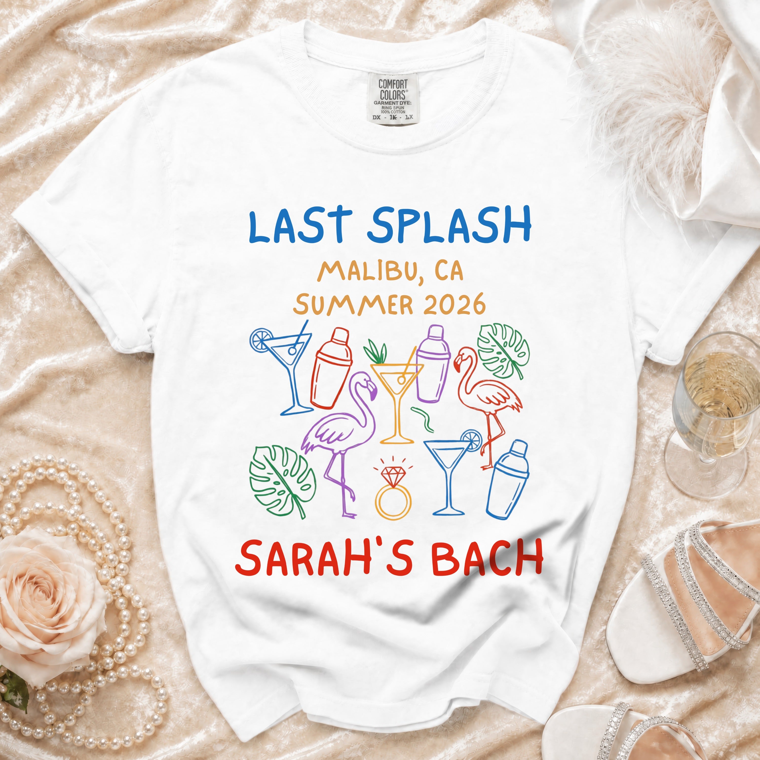 White t-shirt with "Last Splash Malibu, CA Summer 2026 Sarah's Bach" text and graphics.