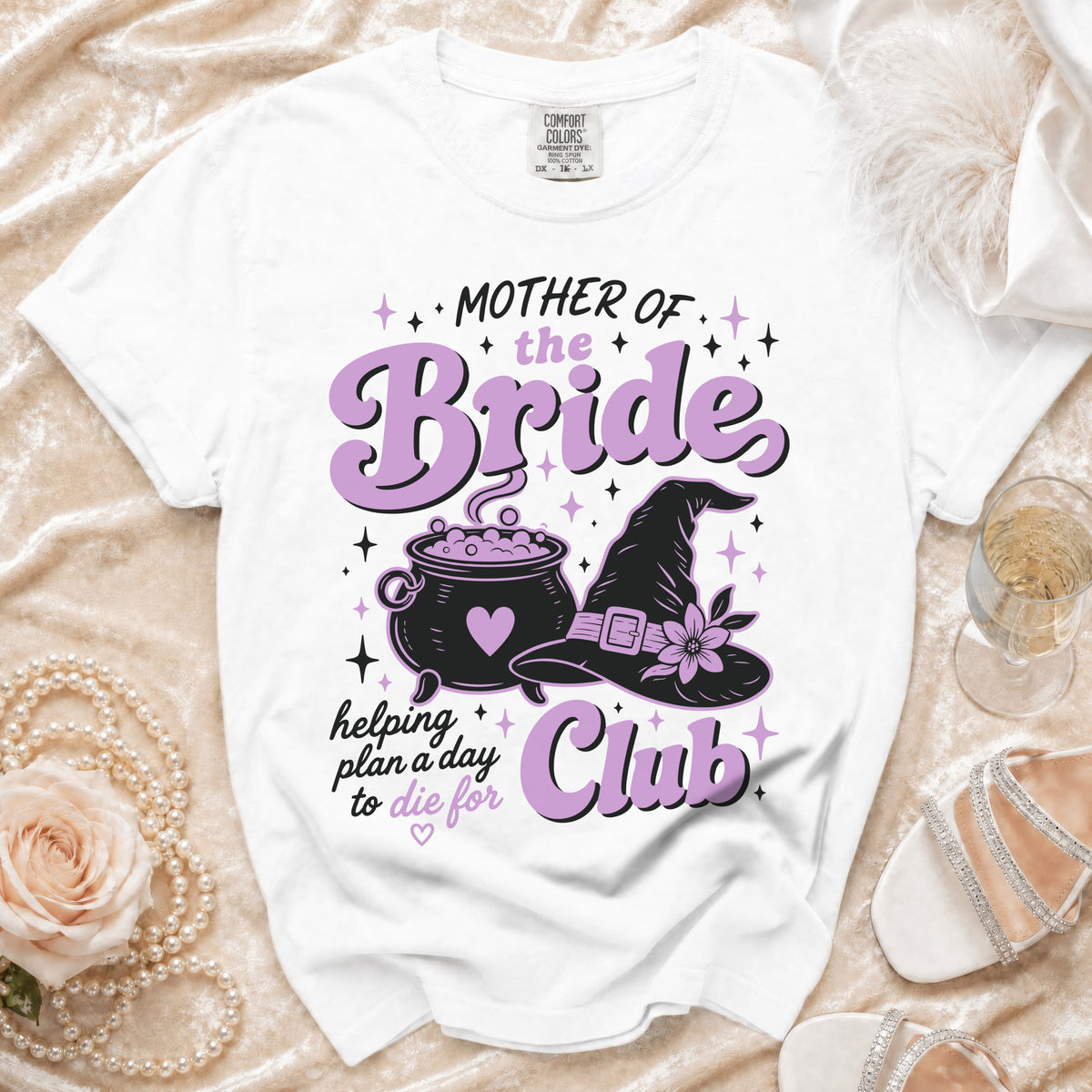 White t-shirt with "Mother of the Bride Club" text and witchy graphics.