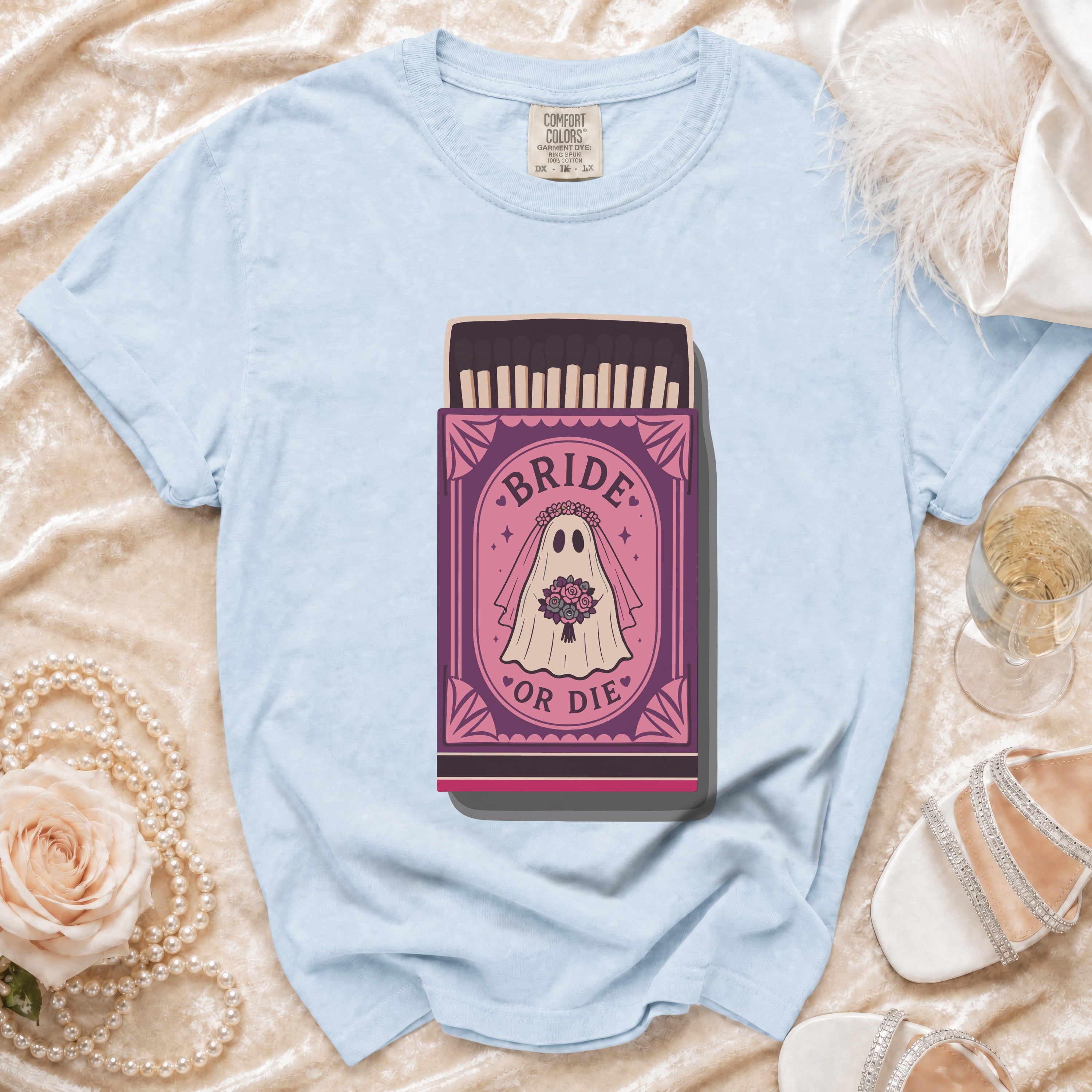 Light blue t-shirt with "Bride or Die" ghost in matchbox graphic.