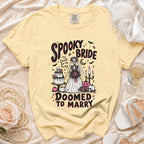 Yellow t-shirt with "Spooky Bride 'Til Death Do Us Party Doomed To Marry" graphic.