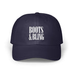 A dark blue baseball cap featuring white embroidered text that reads Boots & Bling on the front.
