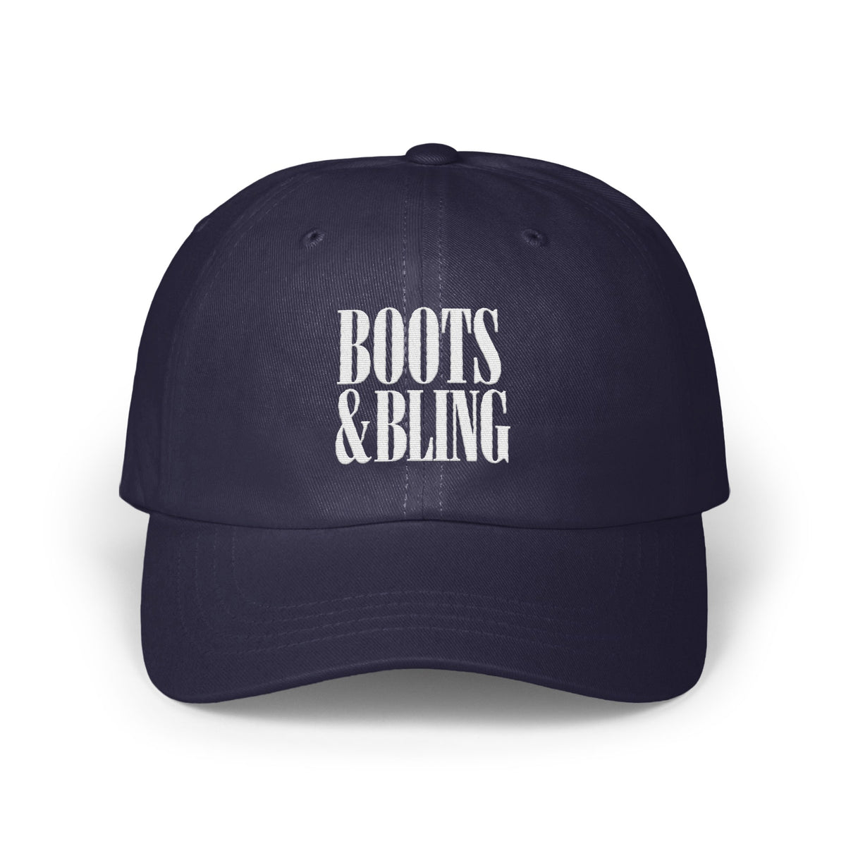 A dark blue baseball cap featuring white embroidered text that reads Boots & Bling on the front.