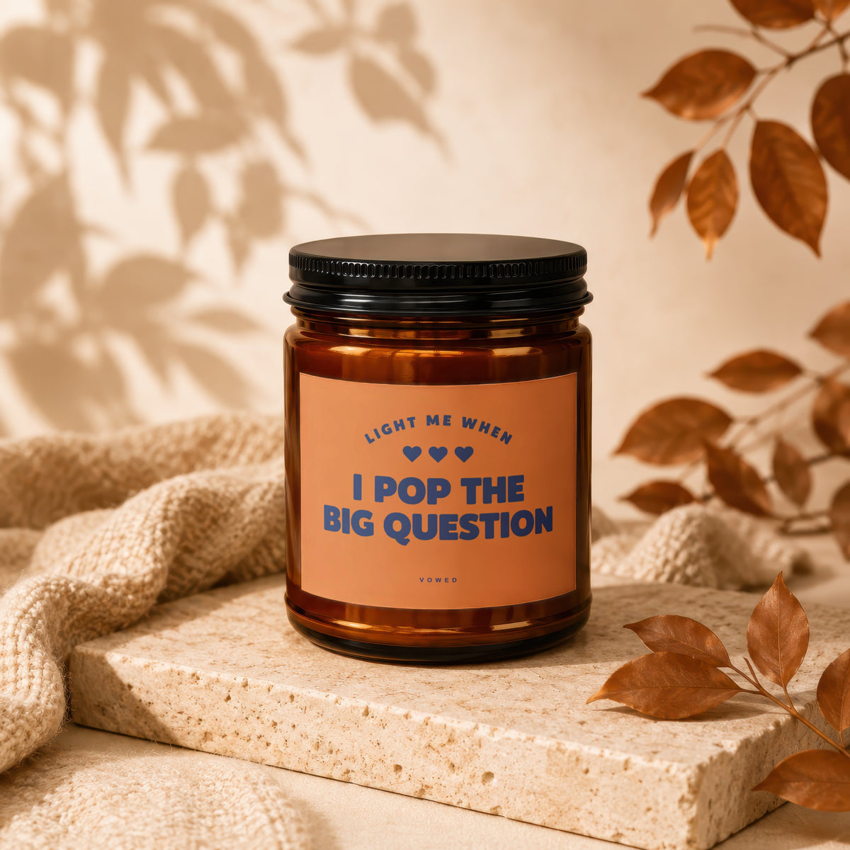 Candle with black lid and label reading "LIGHT ME WHEN I POP THE BIG QUESTION"