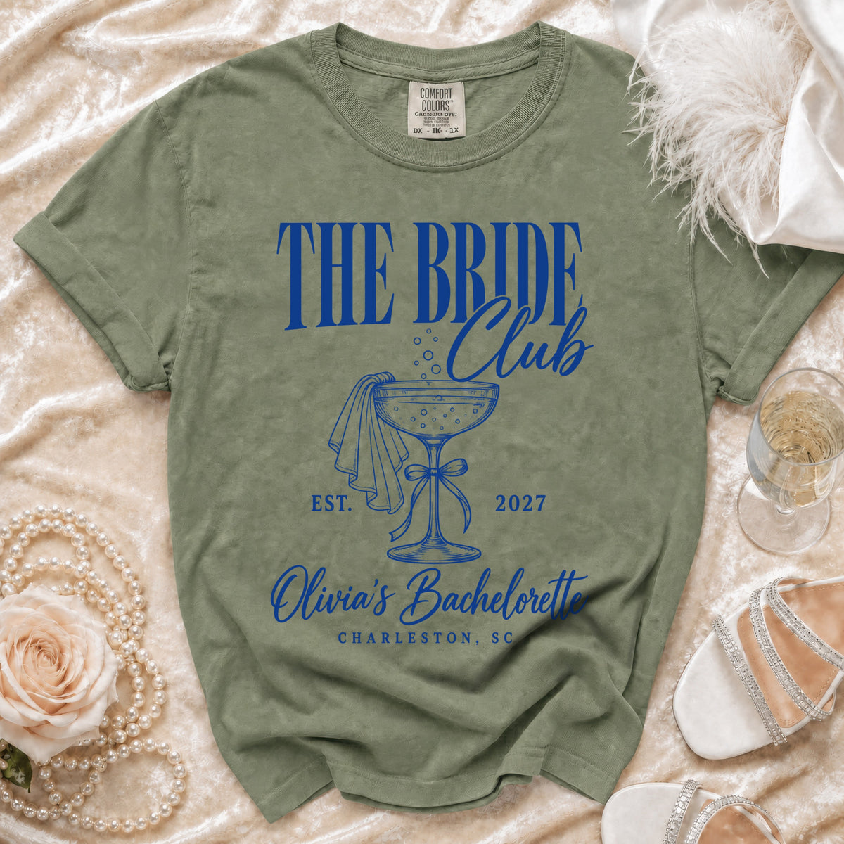 Olive green t-shirt with blue text "The Bride Club" and "Olivia's Bachelorette Charleston, SC".