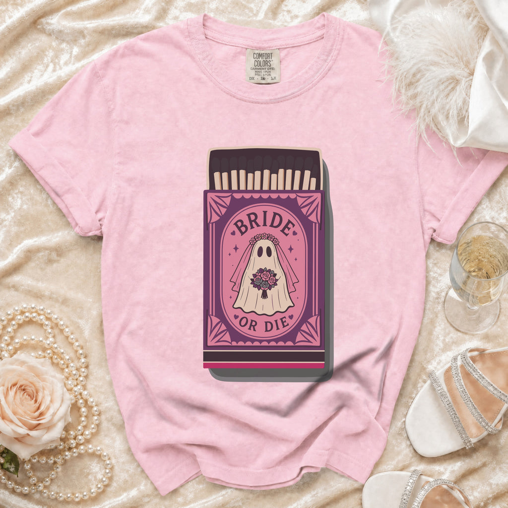 Pink t-shirt with a "Bride or Die" ghost bride graphic on a matchbox.