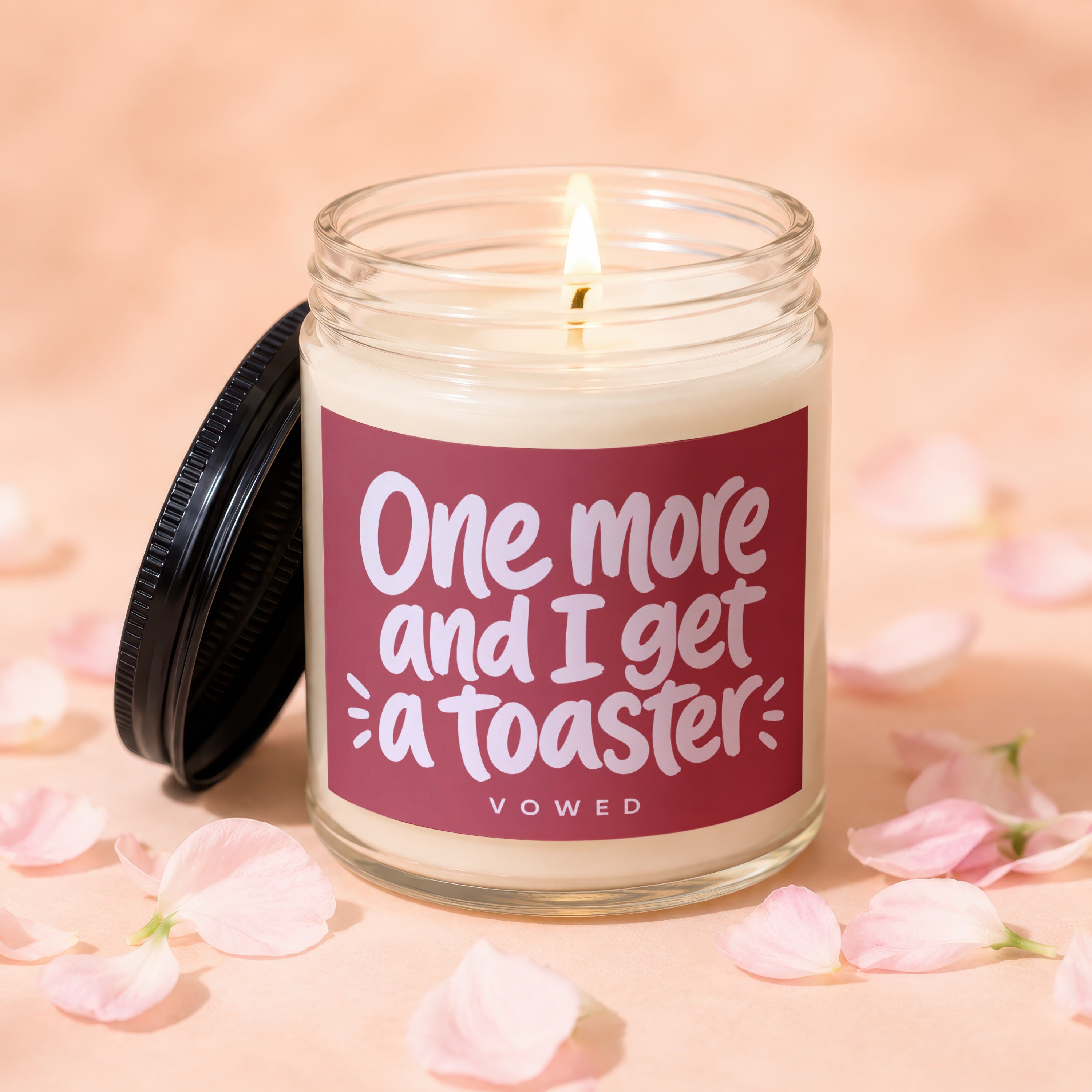 Candle with text "One more and I get a toaster" in a glass jar with lid.