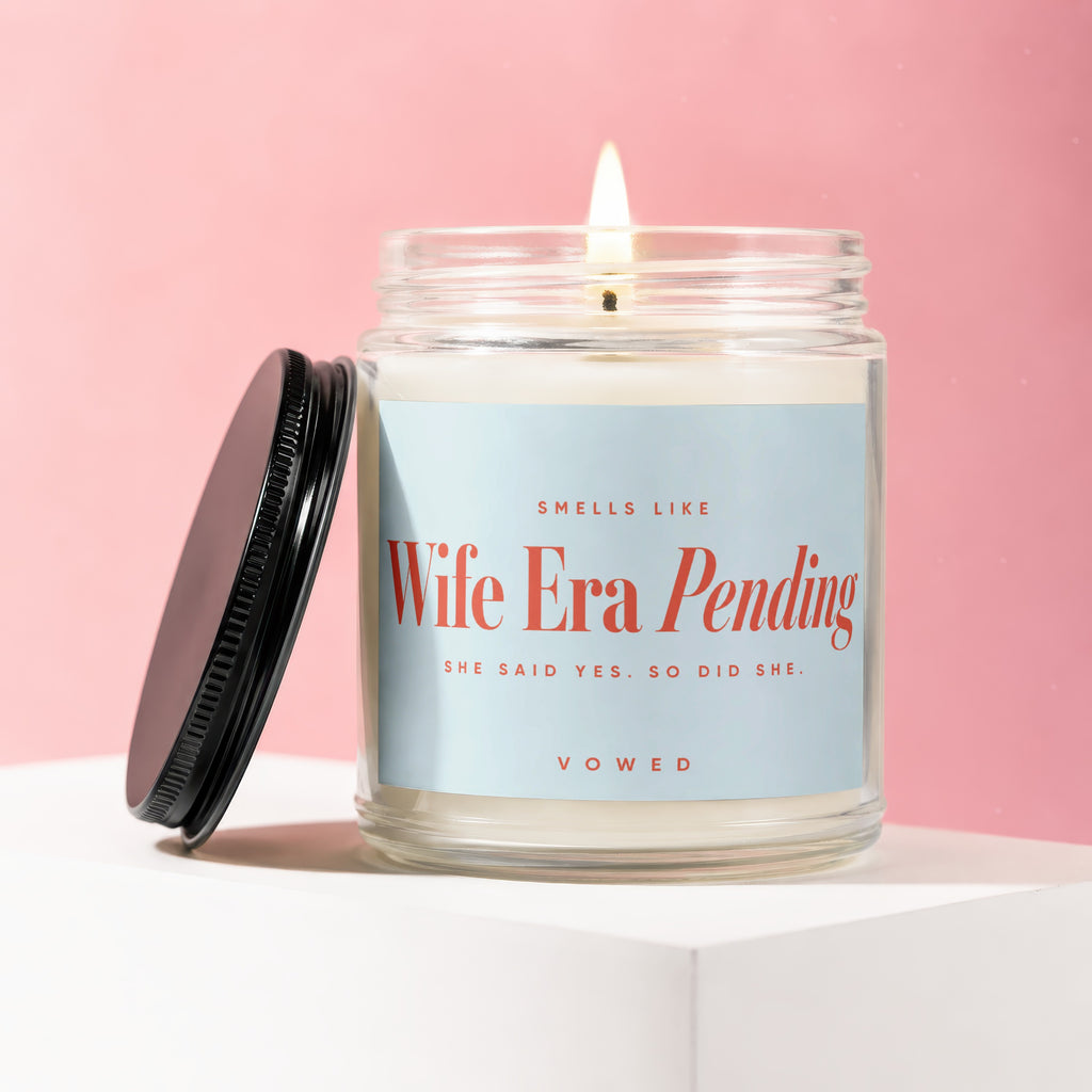 Candle labeled "Wife Era Pending," "She Said Yes. So Did She."
