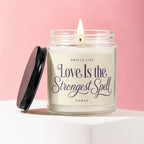 Scented jar candle with pink background, reads "Love Is the Strongest Spell".
