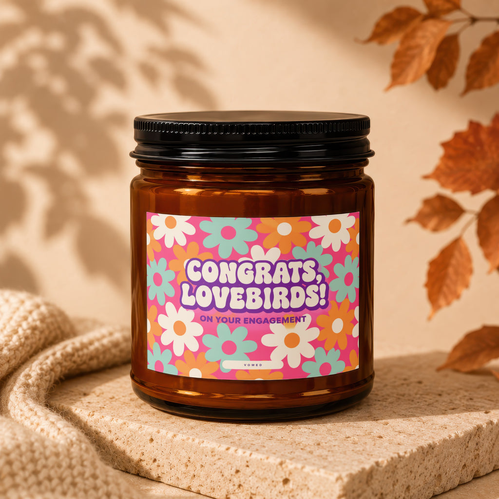 Amber candle with "Congrats, Lovebirds! On Your Engagement" text on a floral label.
