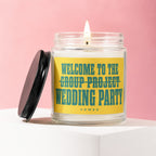 Candle with "Welcome to the group project wedding party" text on a pink background.