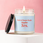 Candle with lit wick and black lid, reads "Maid of Honor Reply: Maybe Yes."
