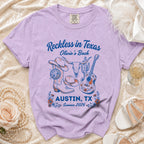 Purple t-shirt with "Reckless in Texas Olivia's Bach Austin, TX Summer 2026" design.