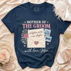 Navy blue t-shirt reads "Mother of the Groom" with envelope and floral design.