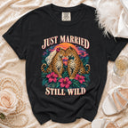 Black t-shirt with "Just Married Still Wild" text and two leopards in a tropical sunset.