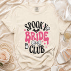 Cream t-shirt with "Spooky Bride Club" text and Halloween graphics.