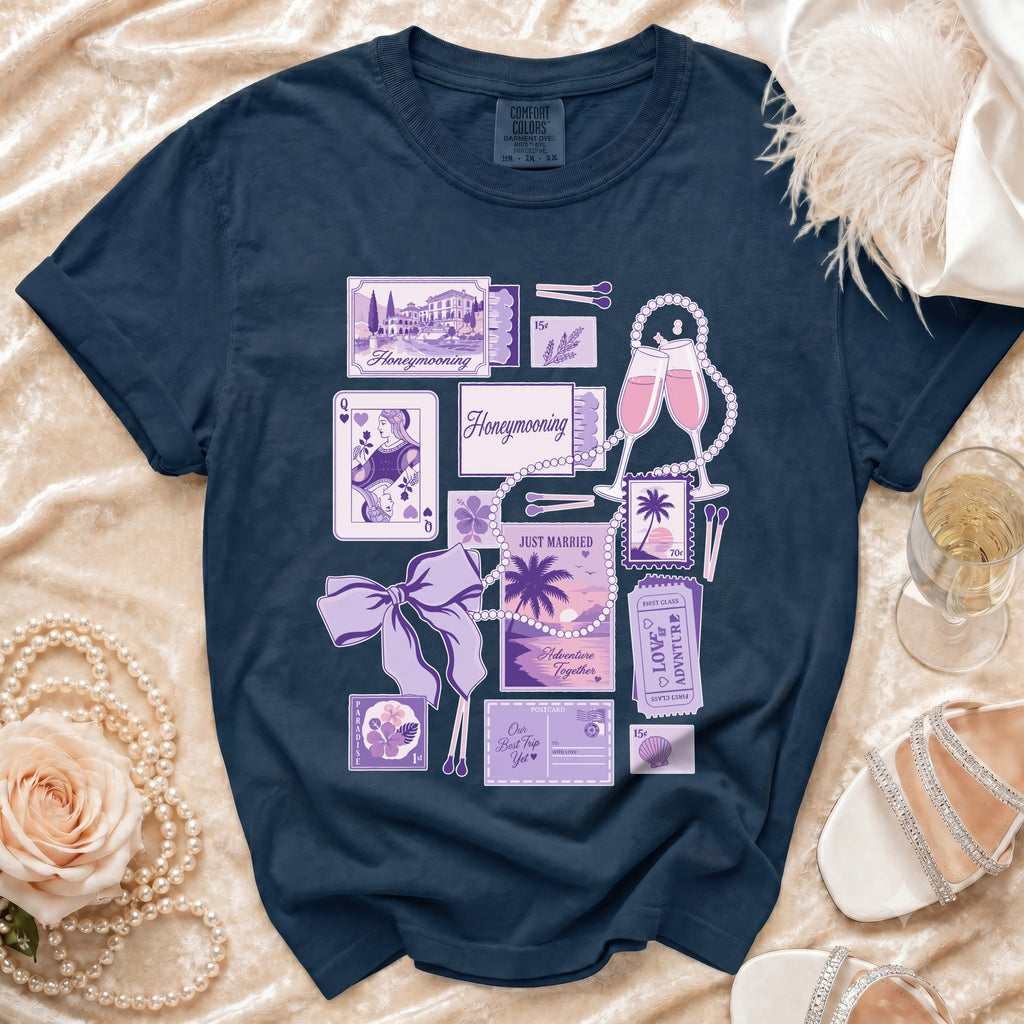Navy t-shirt with "Honeymooning" and travel-themed graphics in purple.