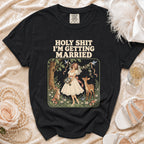 Black t-shirt with "HOLY SHIT I'M GETTING MARRIED" text and forest illustration.