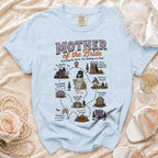 Light blue t-shirt with "Mother of the Bride" graphic and wedding-themed illustrations.