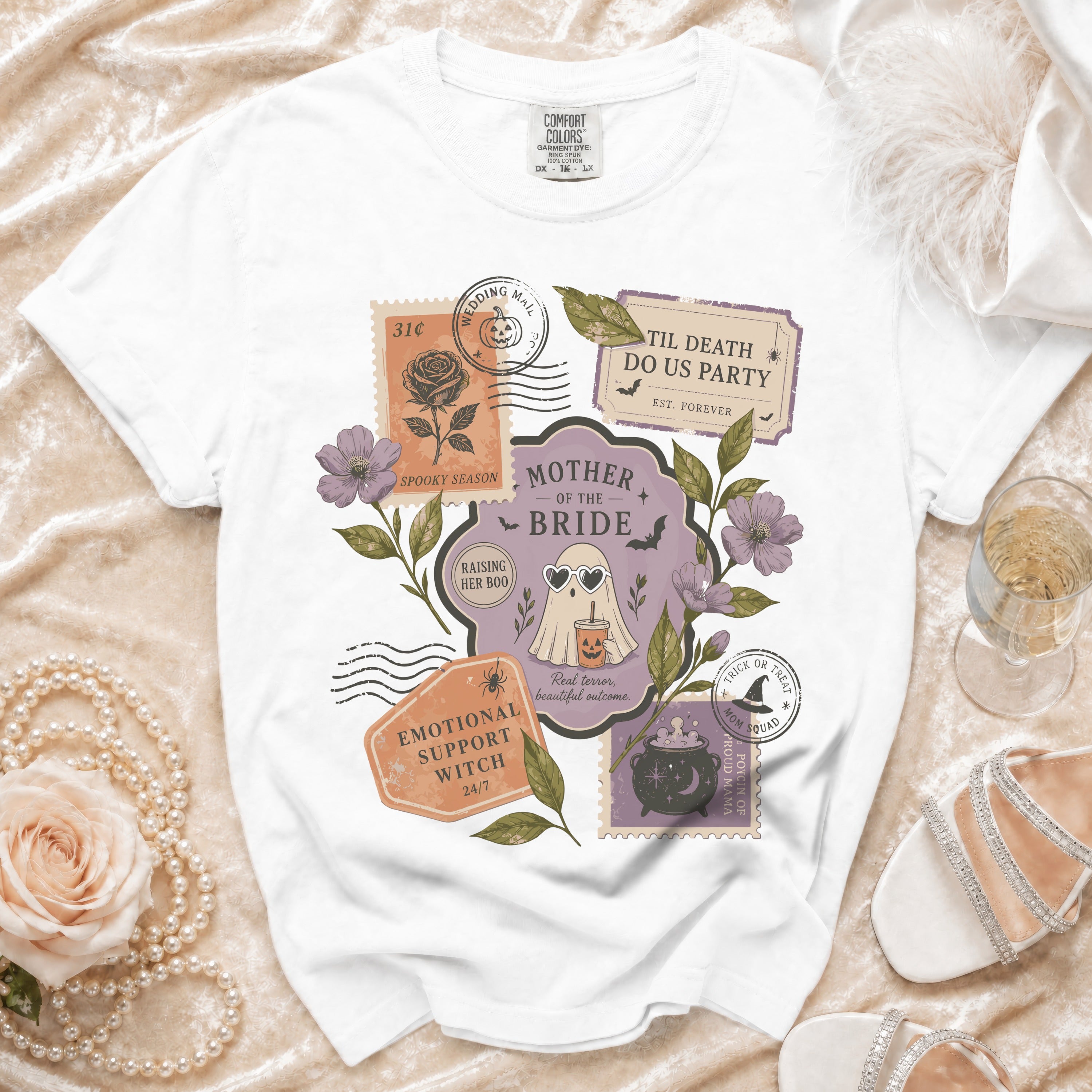 White t-shirt with Halloween-themed "Mother of the Bride" graphic featuring stamps.