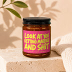Amber jar candle with pink label text "LOOK AT YOU GETTING MARRIED AND SH*T VOWED | 100% SOY WAX".