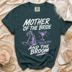 Teal t-shirt with "Mother of the Bride and the Broom" text, witch hat, and cocktail.