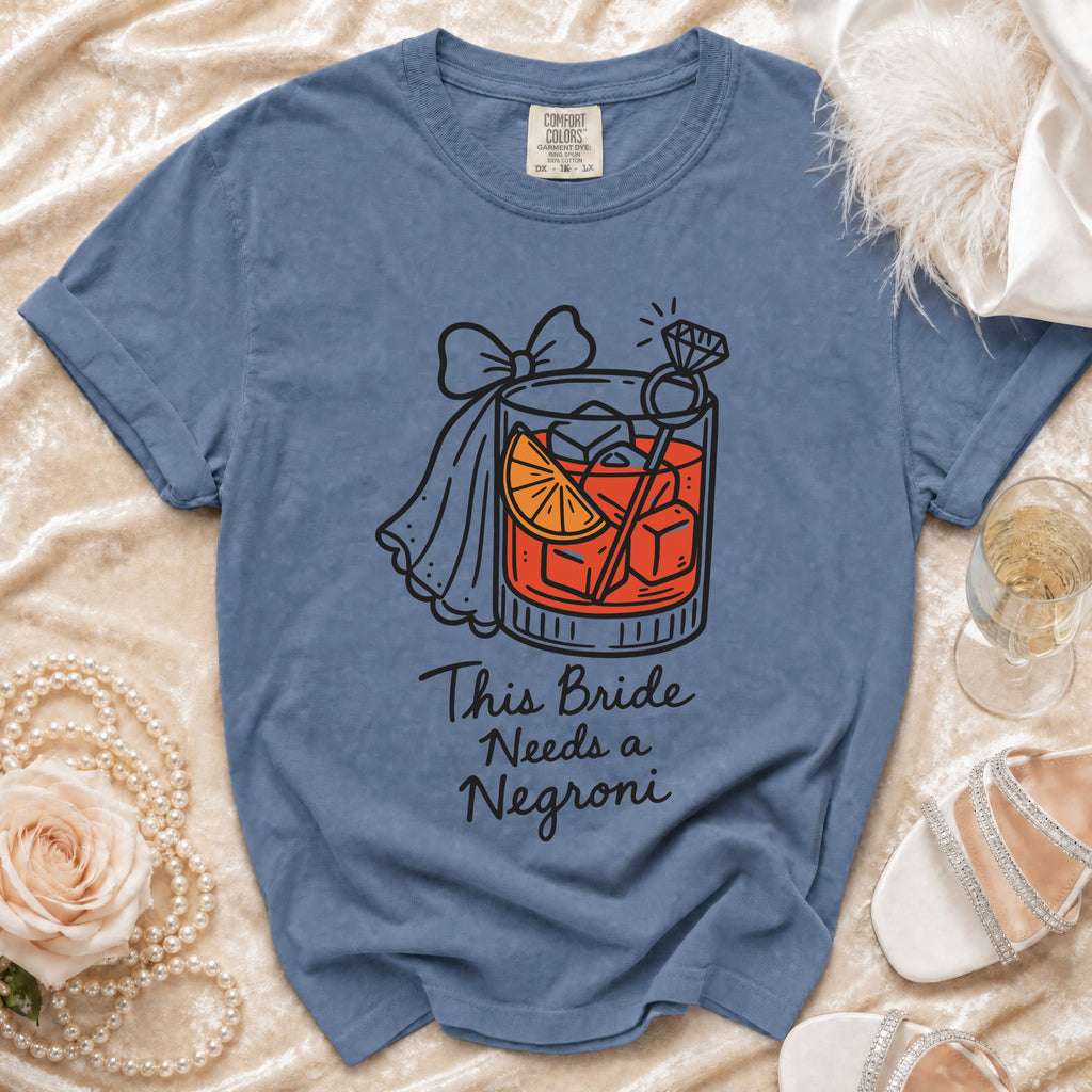 Blue t-shirt with "This Bride Needs a Negroni" text and cocktail graphic.