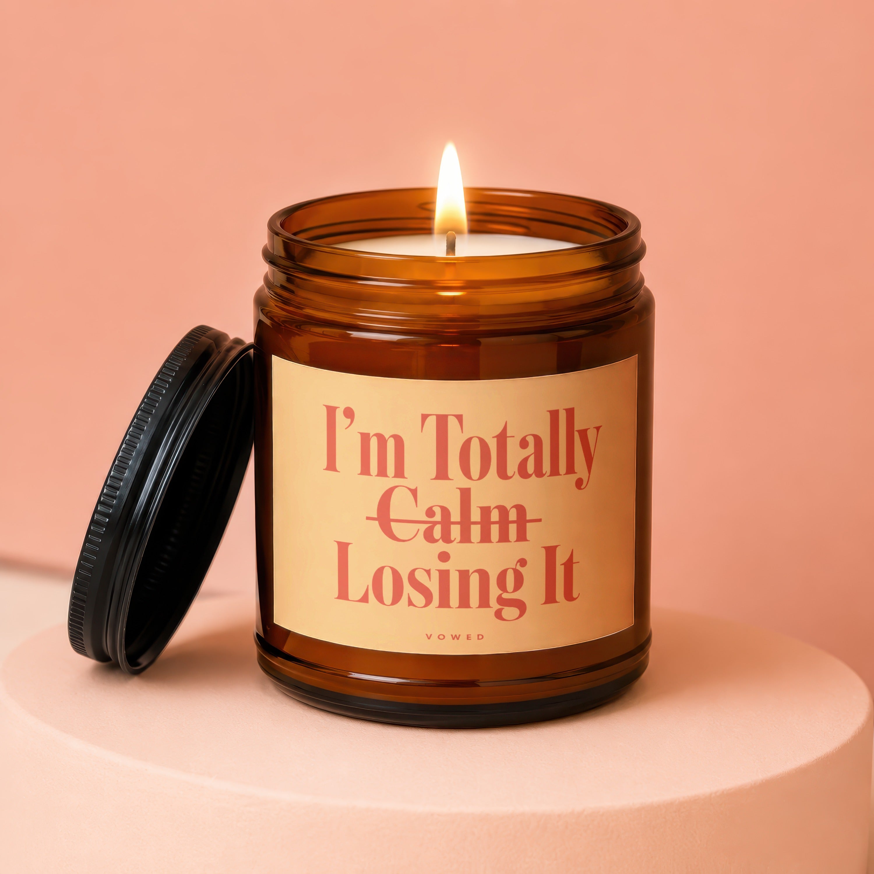 Amber jar candle with lit wick and text "I'm Totally Calm Losing It".