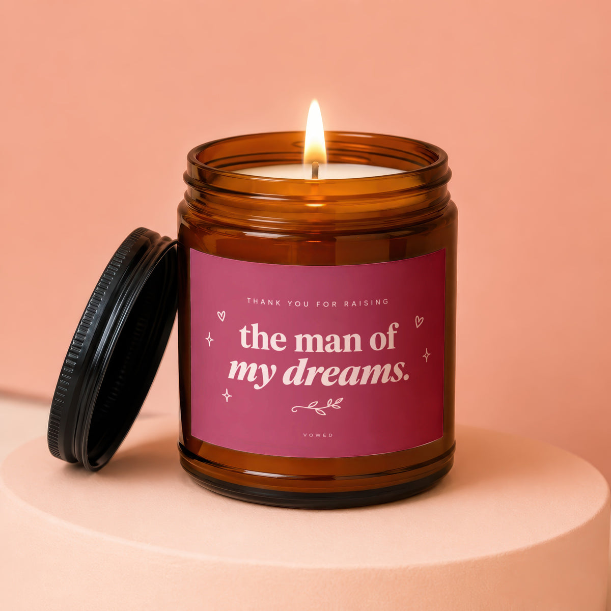Amber jar candle with pink label reading "the man of my dreams".