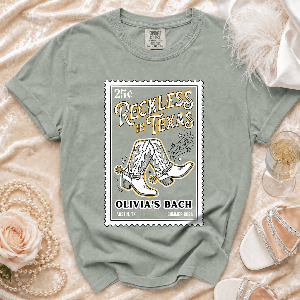 Shirt with "Reckless in Texas" and cowboy boots graphic.