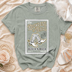 Shirt with "Reckless in Texas" and cowboy boots graphic.