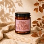 Amber candle with pink label reading "Our officiant is a legend"