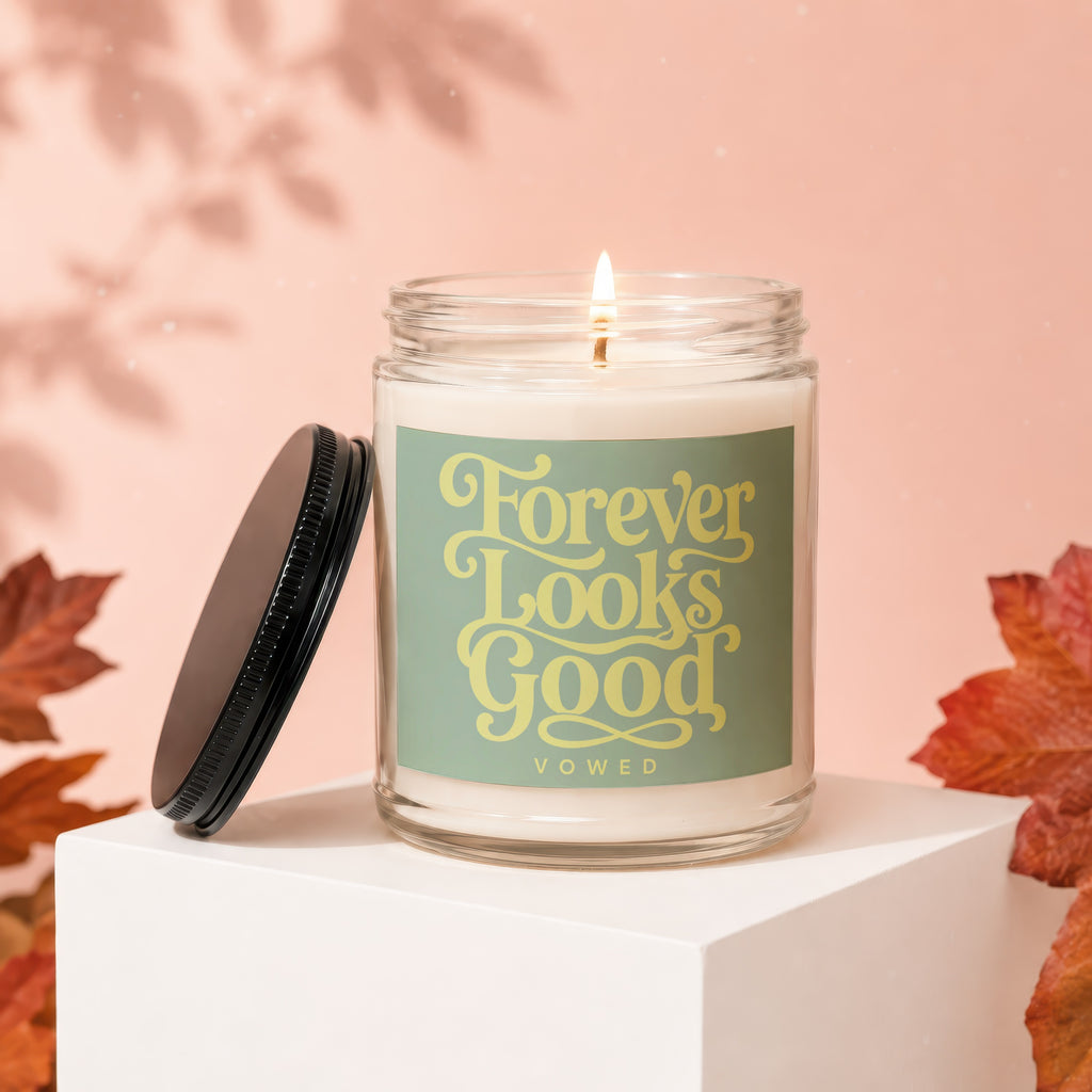 Candle with "Forever Looks Good" text on a dusty rose background.