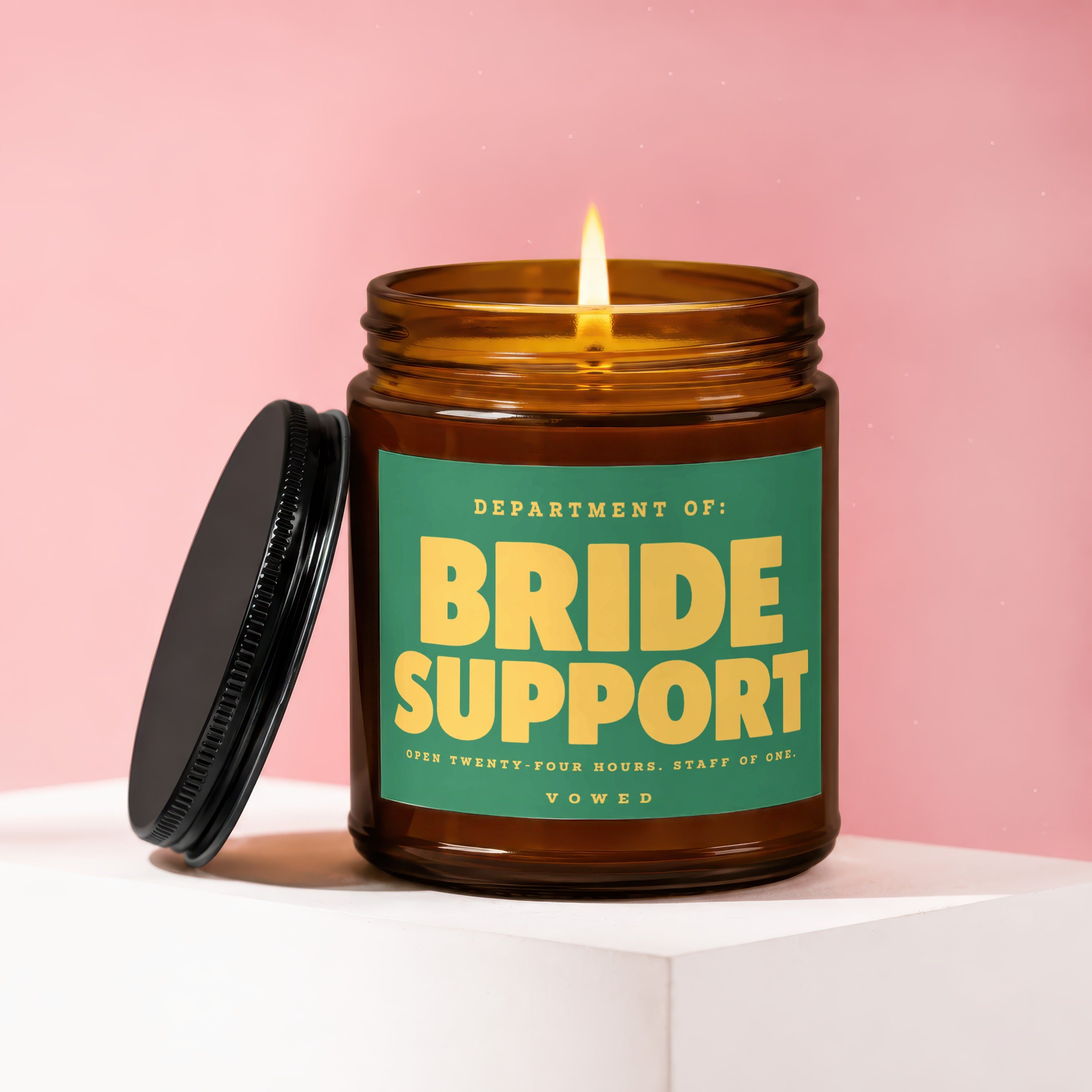 Amber jar candle with lit flame, green label reads "Bride Support".