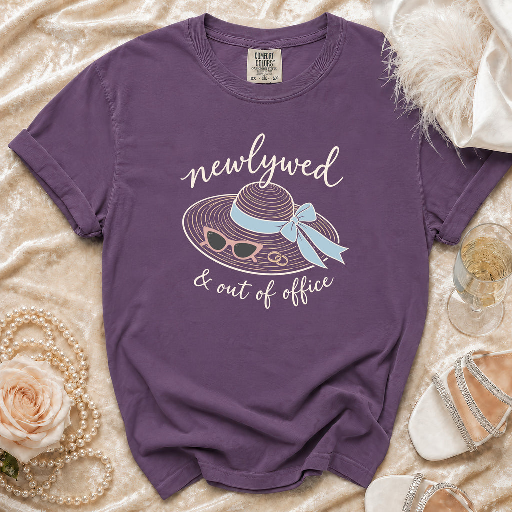 Purple t-shirt with "newlywed & out of office" text and beach accessories graphic.