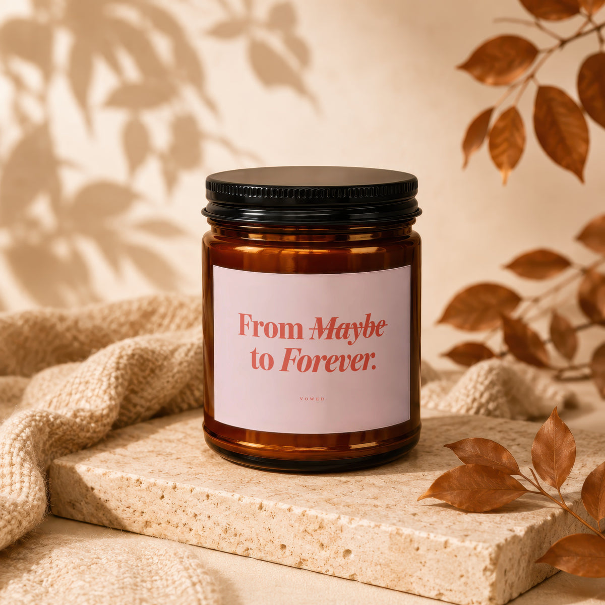 Amber candle with a pink label that reads "From Maybe to Forever."