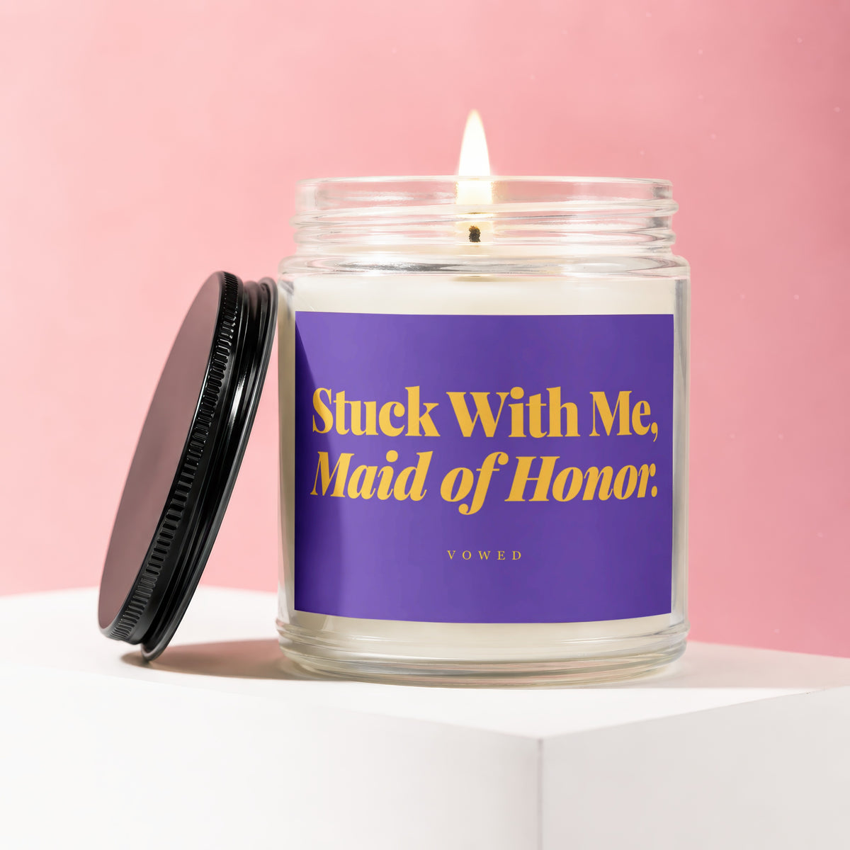 Candle with purple label reading "Stuck With Me, Maid of Honor. VOWED."