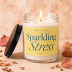 Candle with lit wick and label reading "Smells Like Sparkling Stress"