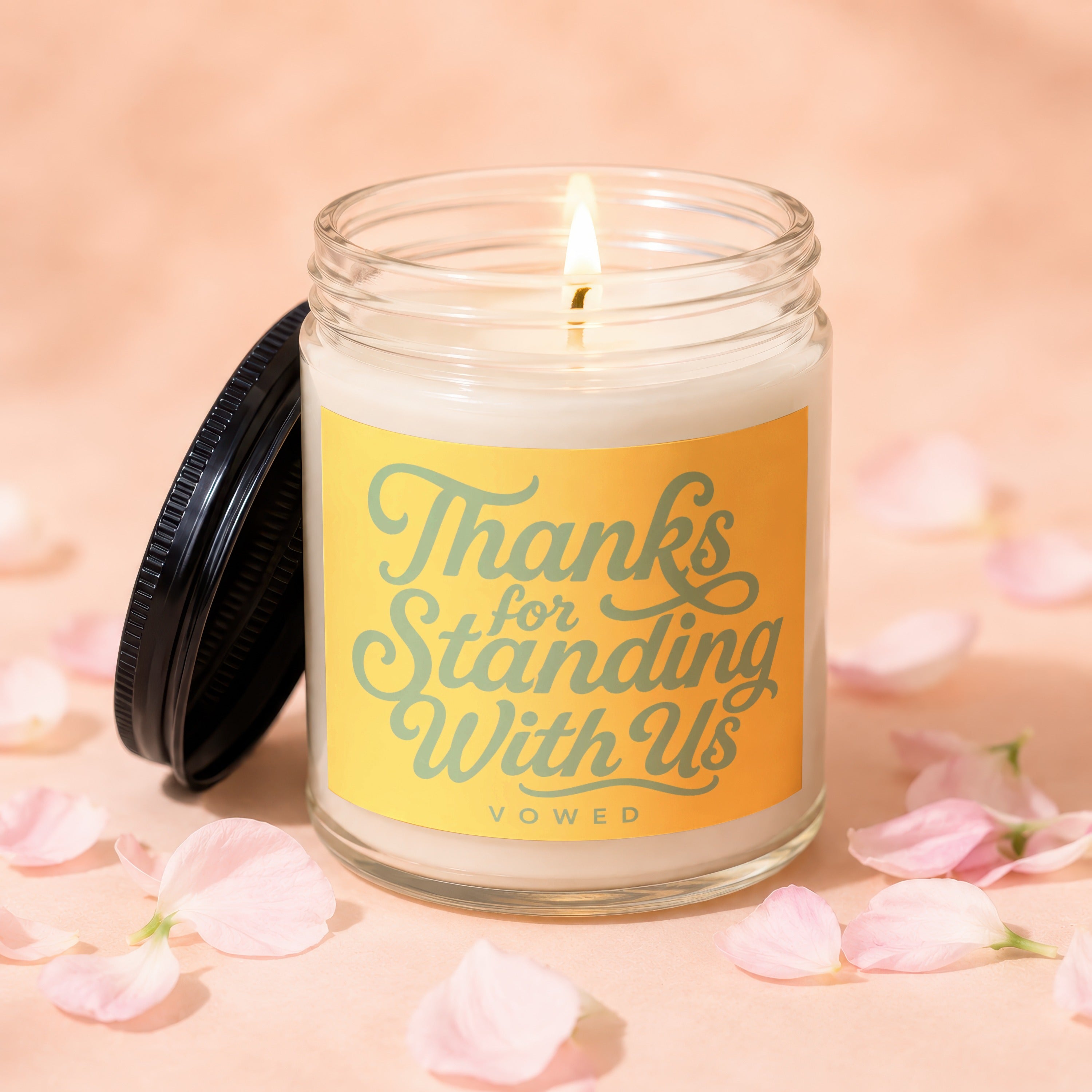 Candle with "Thanks for Standing With Us VOWED" text on yellow label.