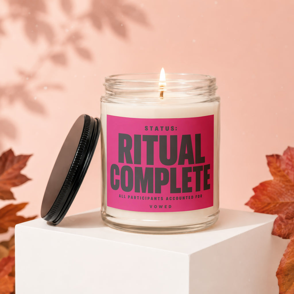 Lit candle with pink label reading "STATUS: RITUAL COMPLETE ALL PARTICIPANTS ACCOUNTED FOR VOWED."